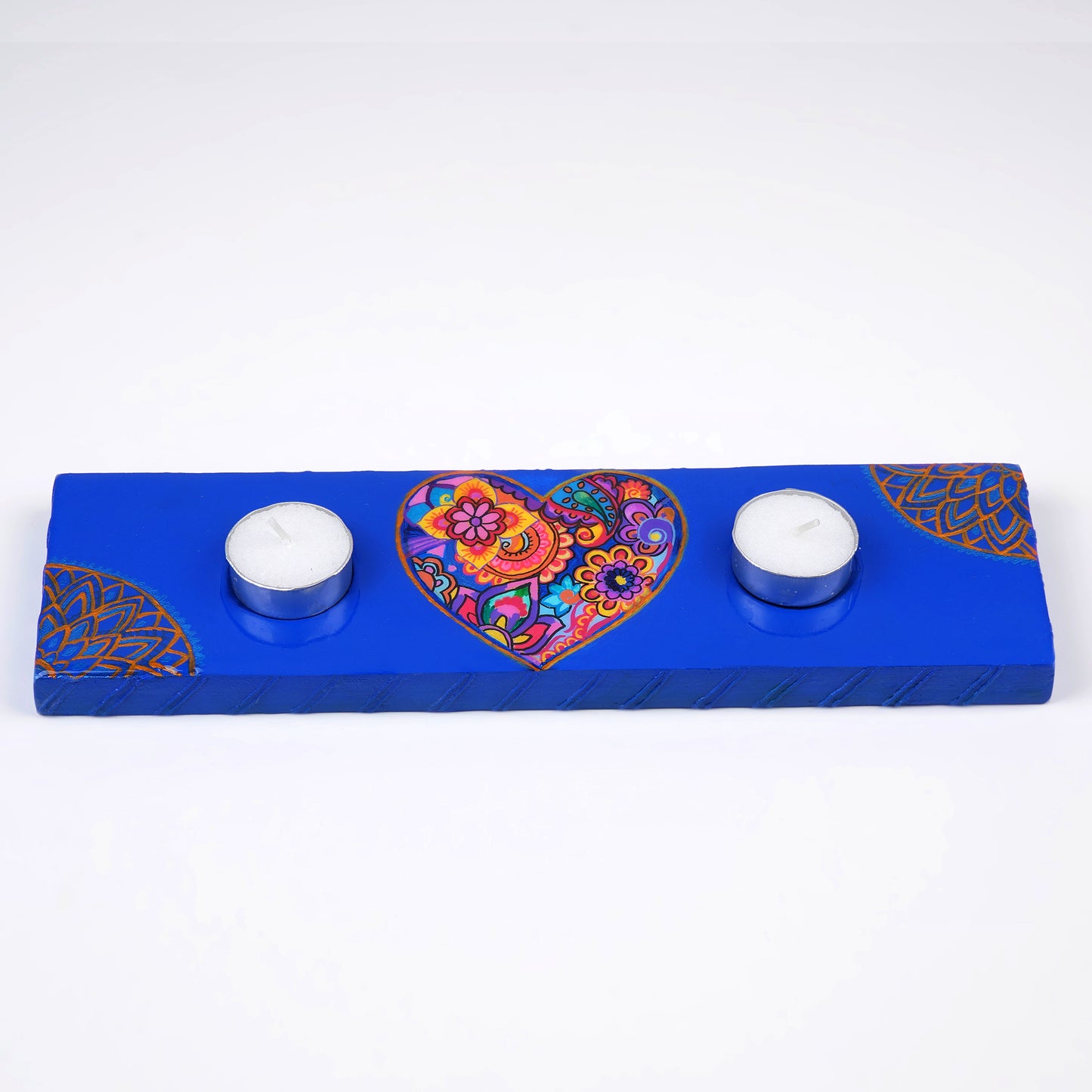 Heart-Maze-Tea-Light-Holder-placed-on-a-surface-with-two-lit-candles.jpg