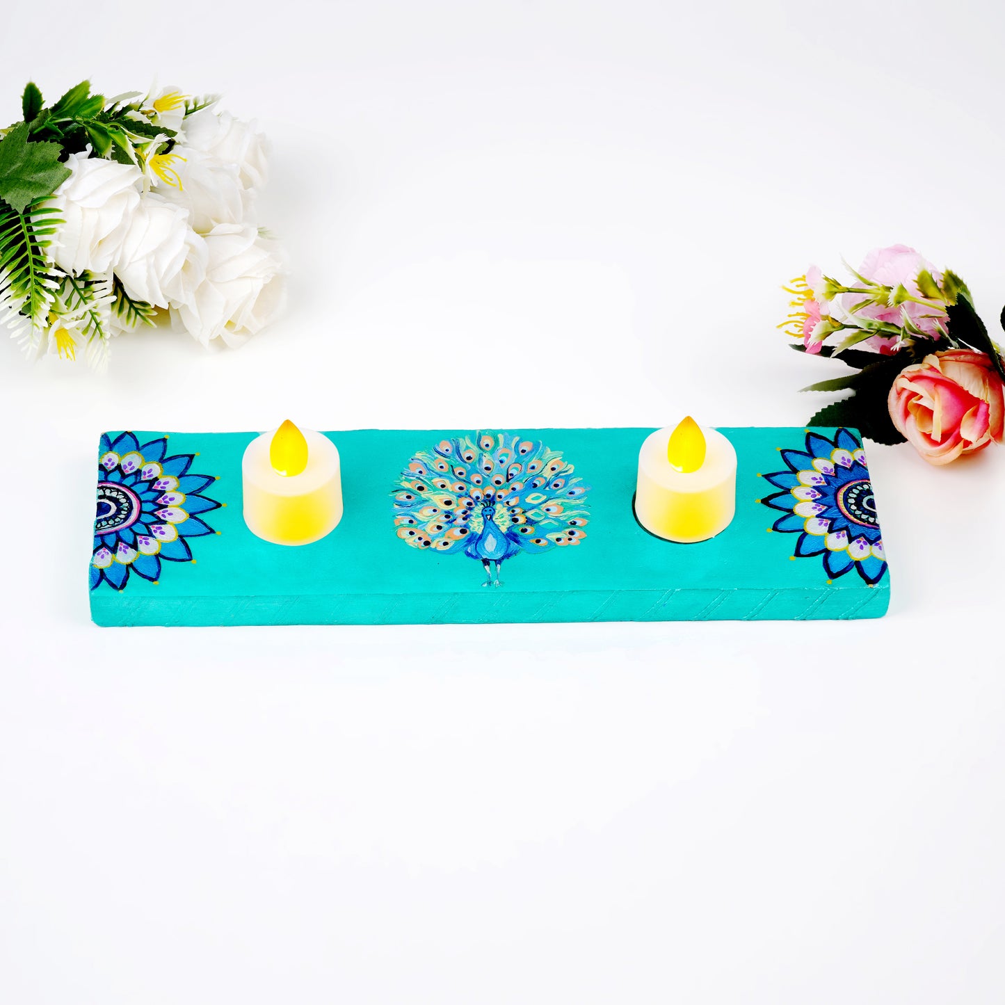 Close-up-of-GlowingPlumes-Tea-Light-Holder-highlighting-detailed-hand-painted-peacock-artwork.jpg