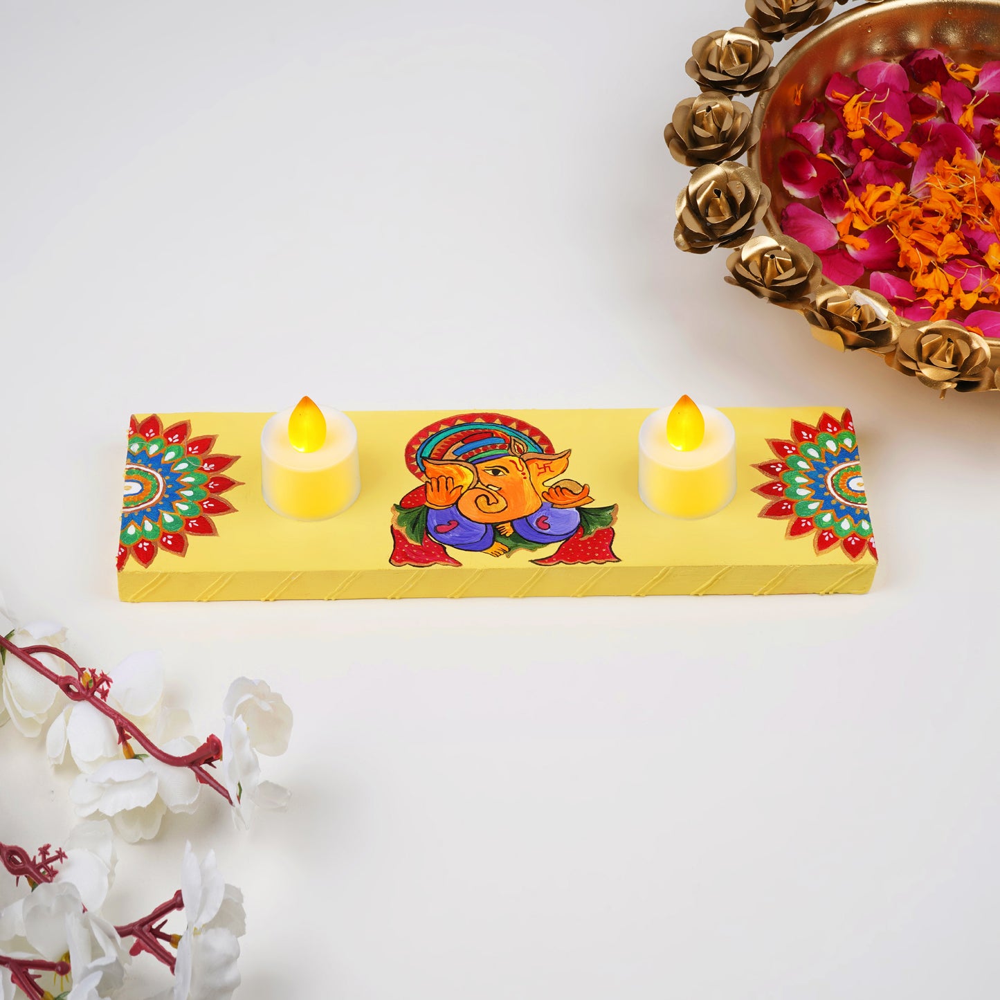 A front view of the Anant Tea Light Holder, showcasing its intricate hand-painted design featuring Ganeshji in vibrant colors