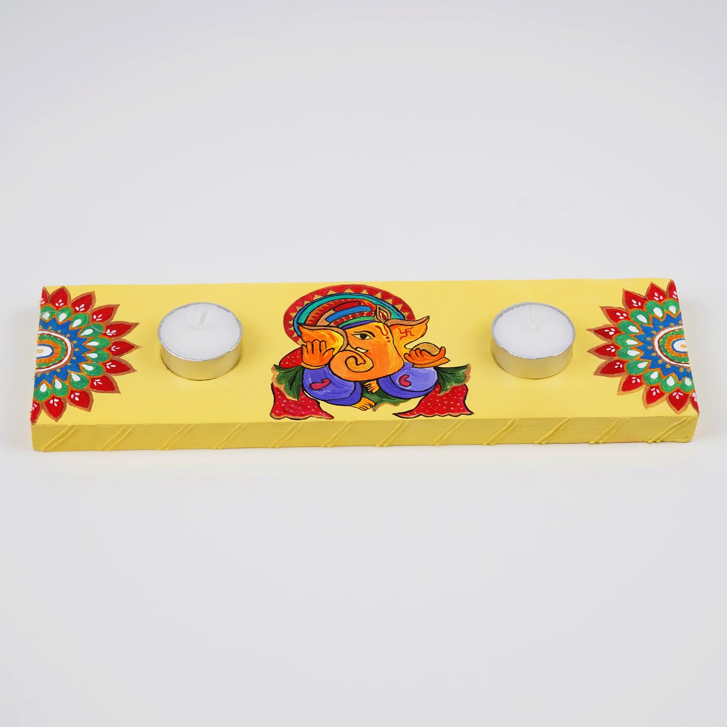 The Anant Tea Light Holder illuminated with tea lights, creating a warm and magical ambiance.